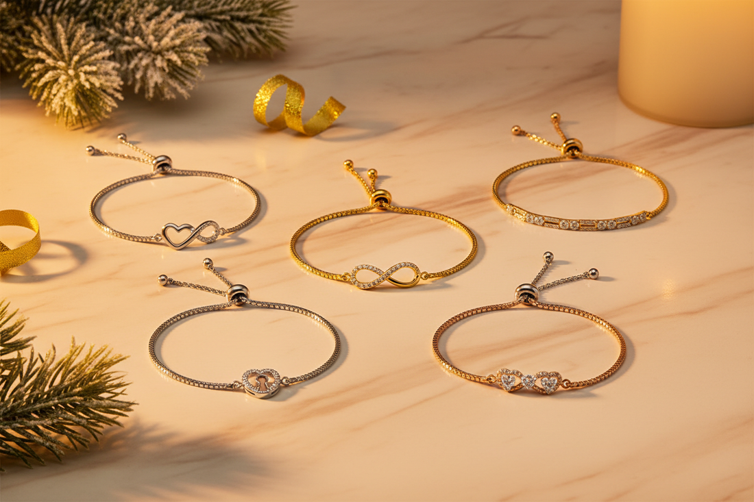 Holiday adjustable bolo bracelet gift guide flat-lay featuring diamond infinity, heart-infinity, linear link, keyhole charm, and rose-plated heart link bolo bracelets on champagne marble — Bijoux NYC Direct