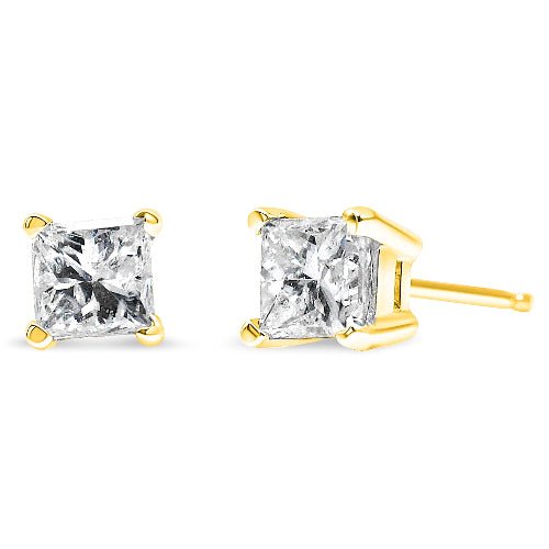 Gold stud earrings with clear gemstones on a white background