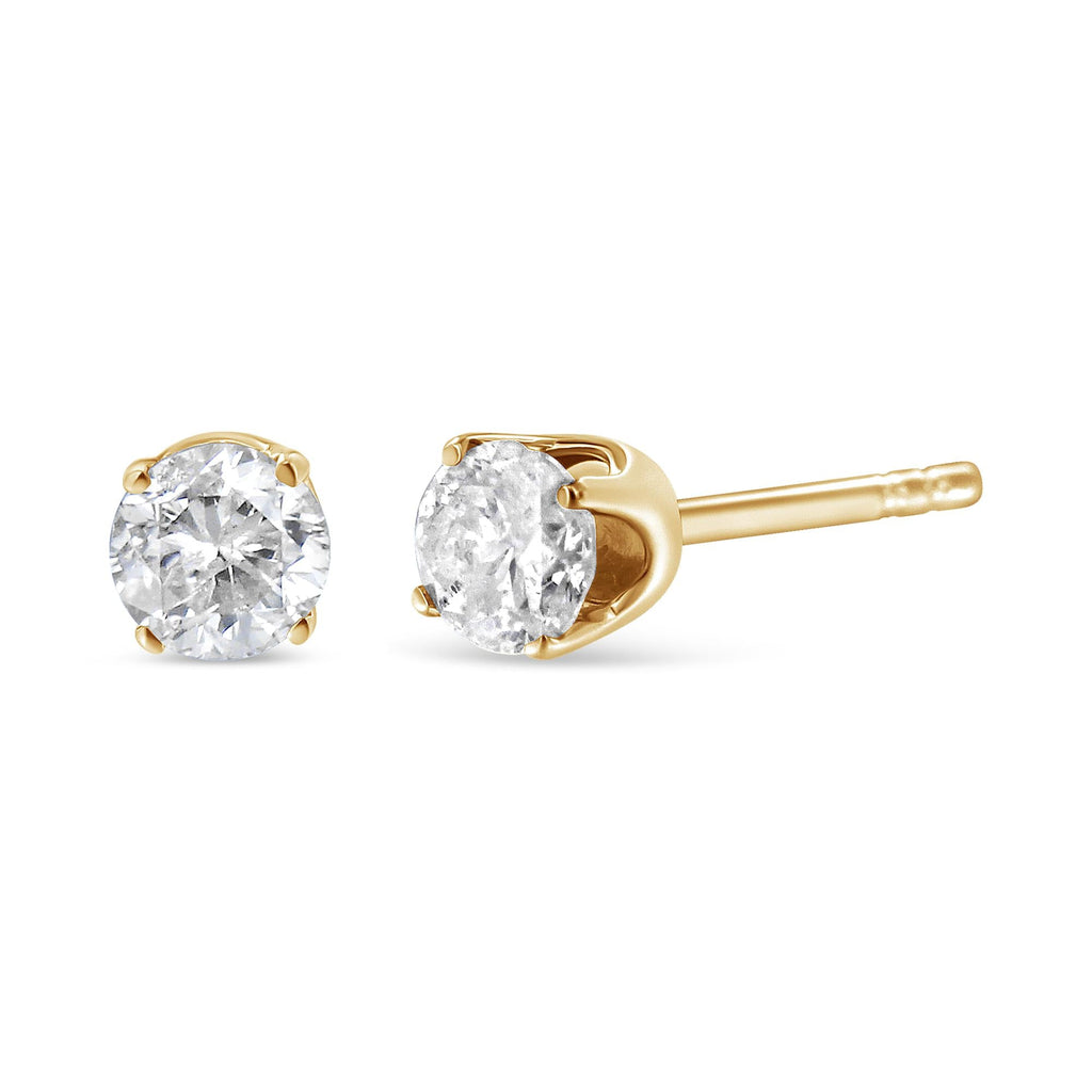 Gold stud earrings with clear gemstones on a white background