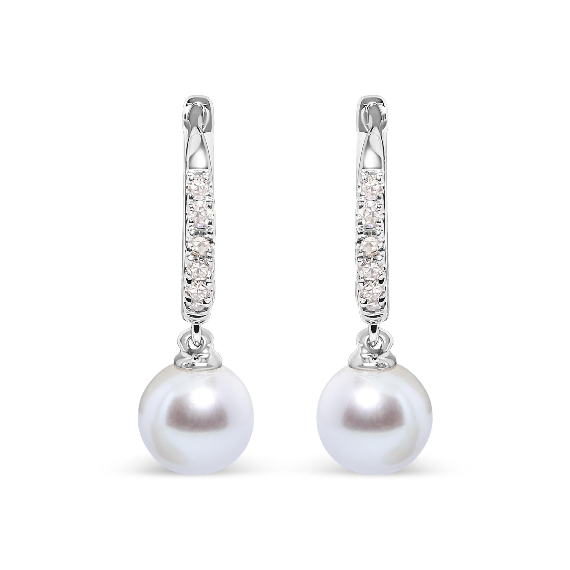 Pearl earrings with diamond accents on a white background