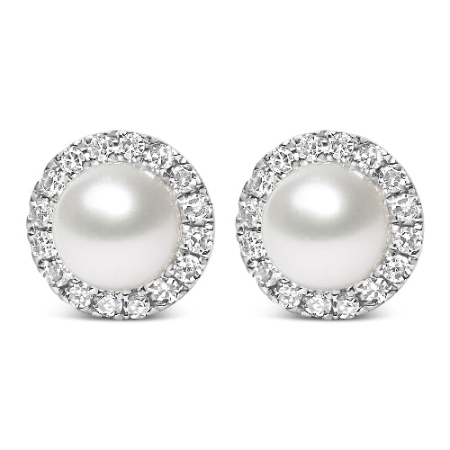 Pair of pearl earrings with diamond-like stones on a white background