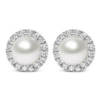 Pair of pearl earrings with diamond-like stones on a white background
