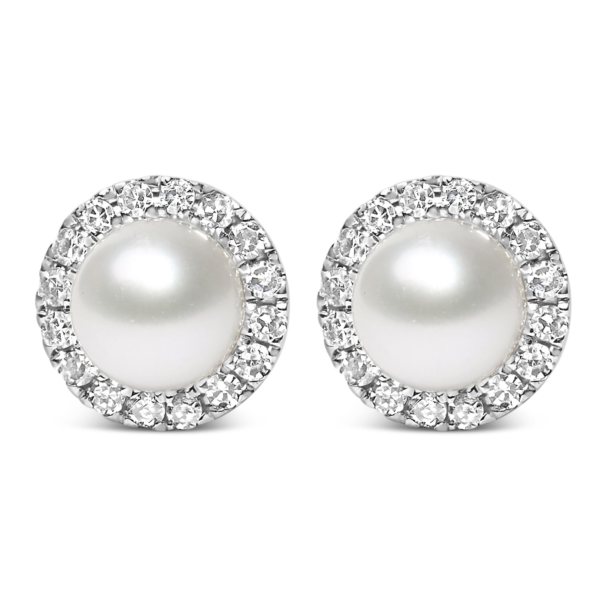 Pair of pearl earrings with diamond-like stones on a white background