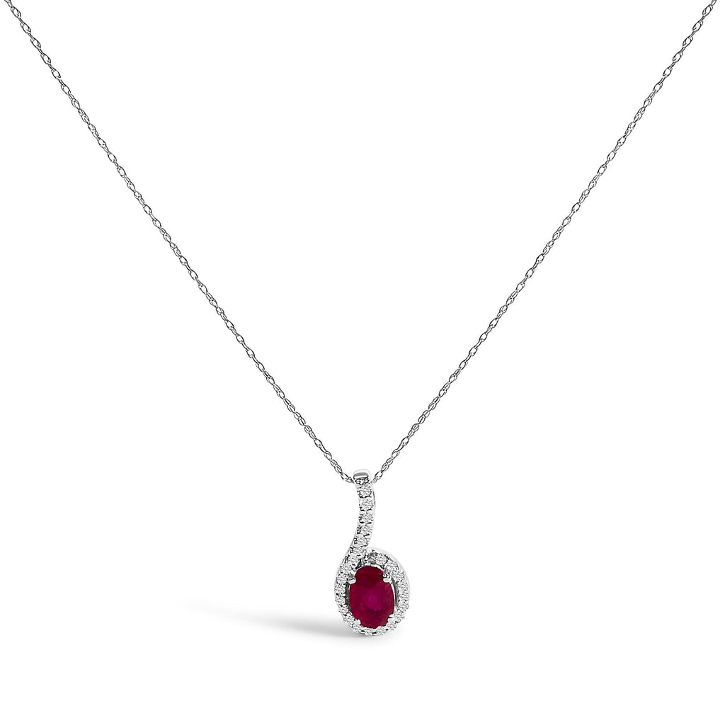 Silver necklace with a red gemstone pendant on a white background