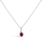 Silver necklace with a red gemstone pendant on a white background