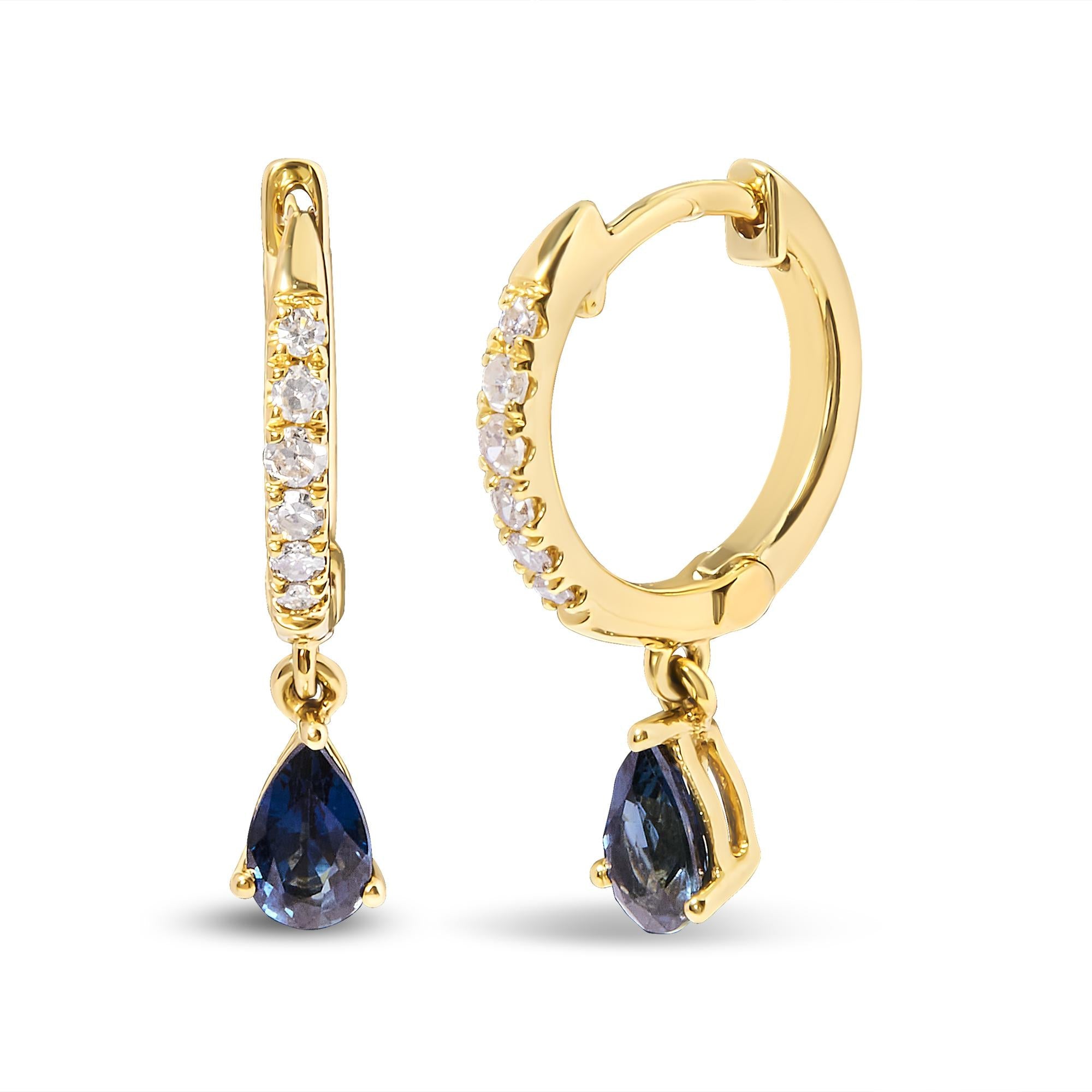 Gold hoop earrings with teardrop-shaped blue gemstones on a white background