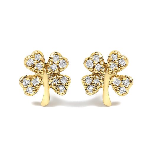 Gold four-leaf clover earrings with diamond accents on a white background