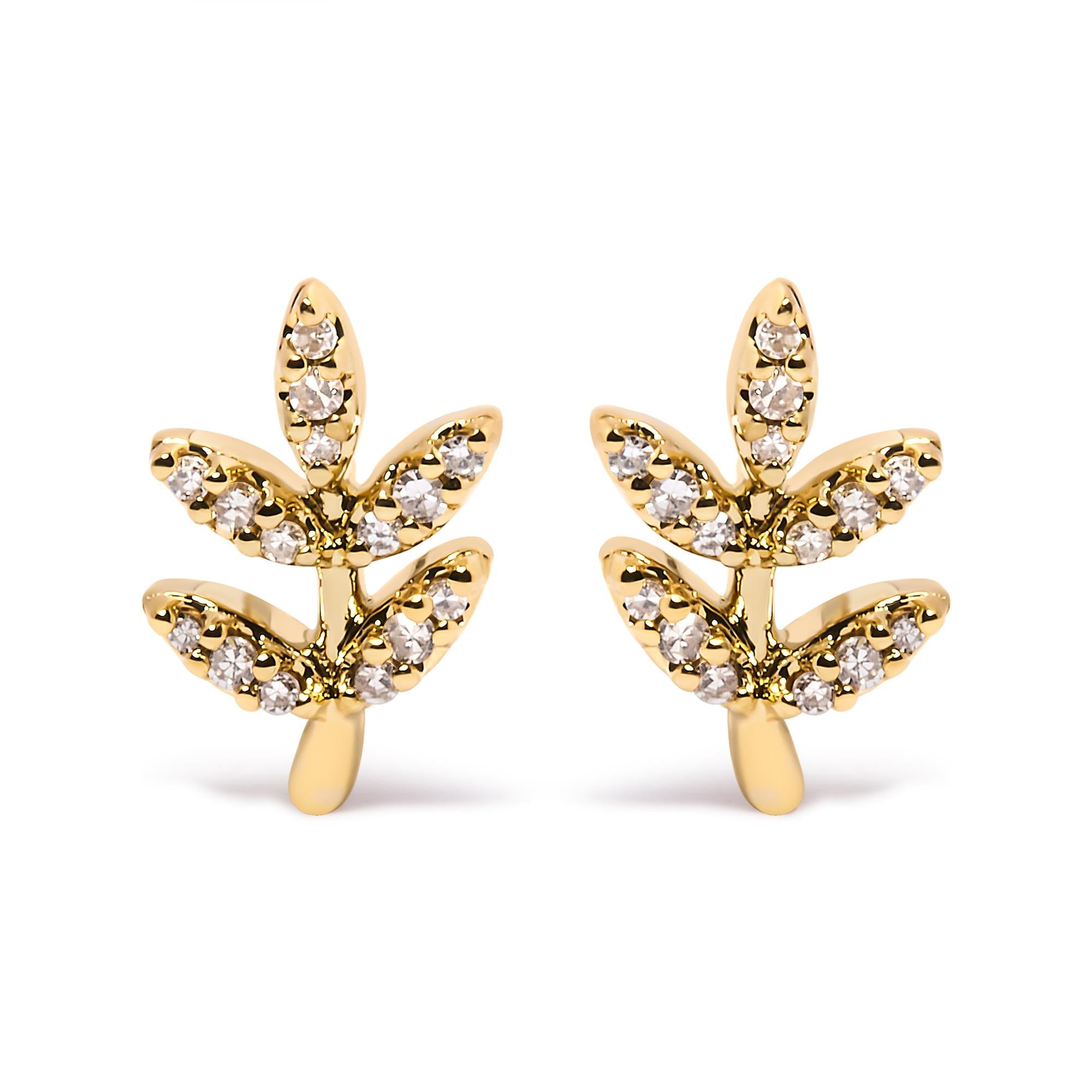 Gold leaf-shaped earrings with embedded diamonds on a white background