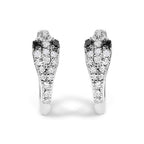 Pair of snake-shaped earrings with black and white gemstones on a white background