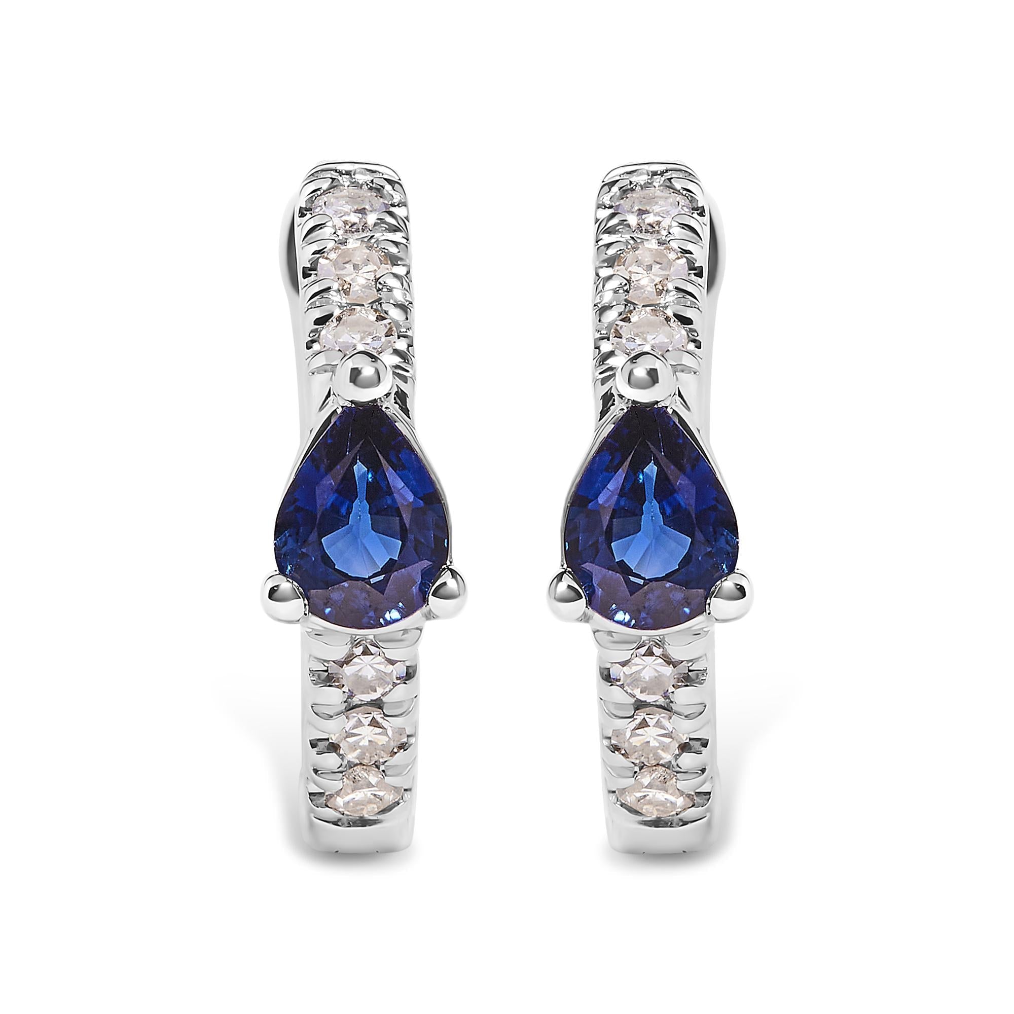 Pair of earrings with blue gemstones and silver accents on a white background