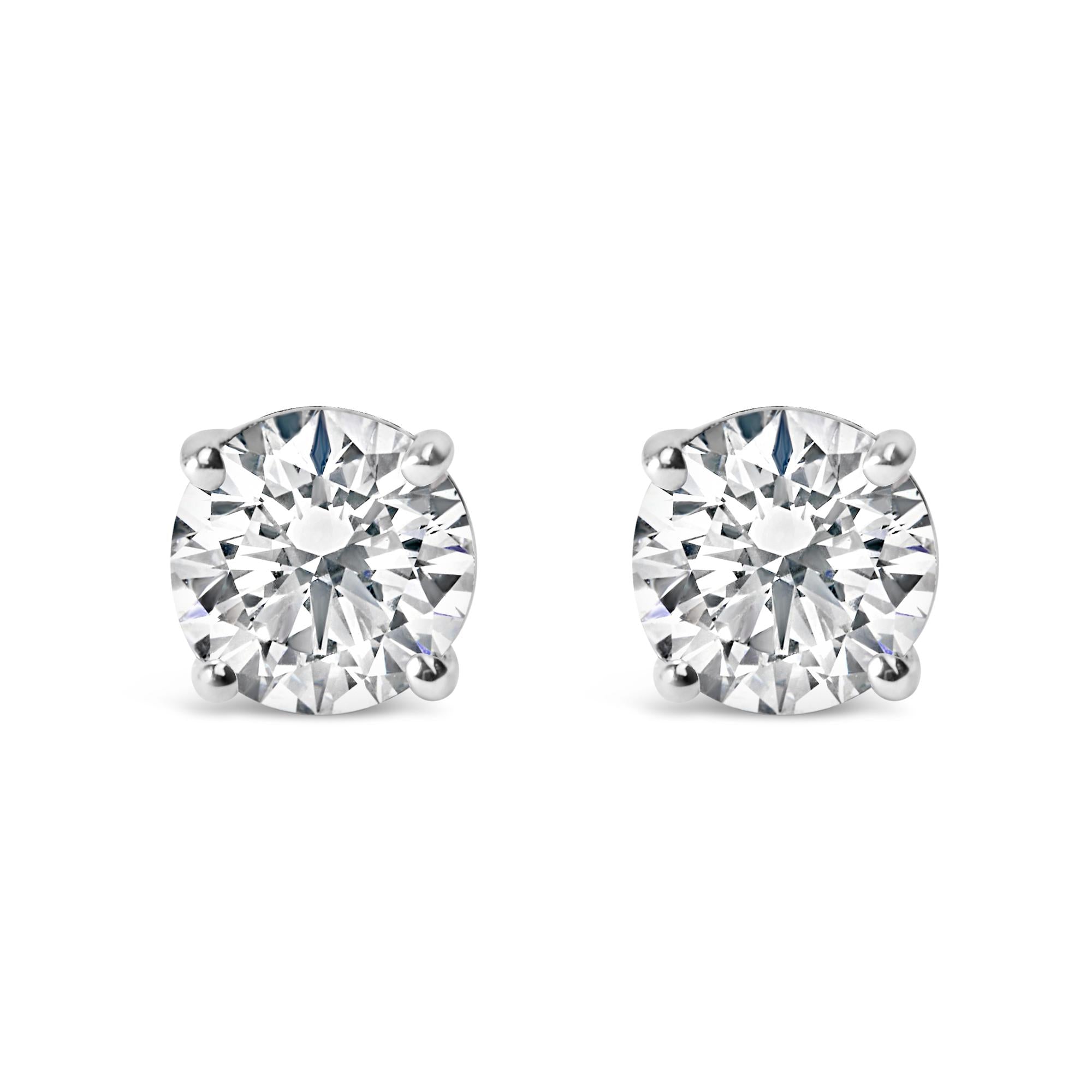 Pair of diamond stud earrings on a white background