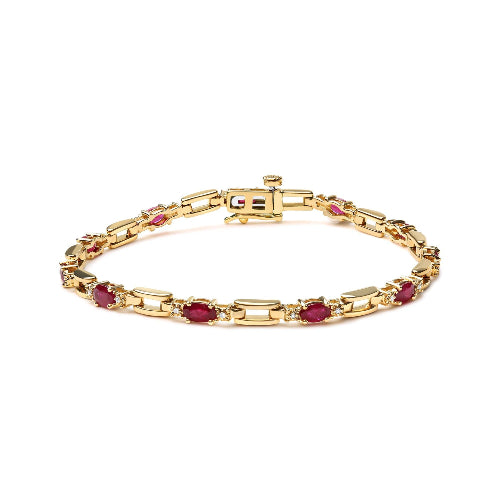 Gold bracelet with red gemstones on a white background