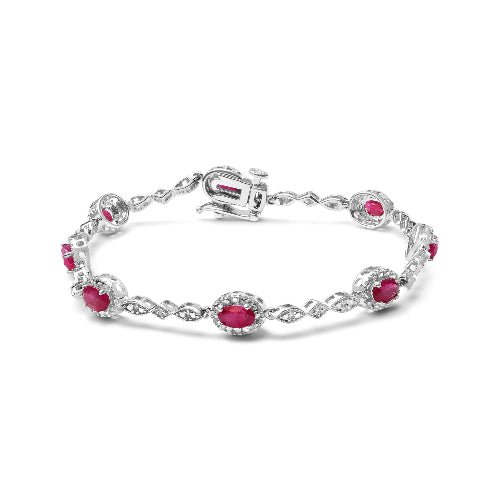 Silver bracelet with red gemstones on a white background