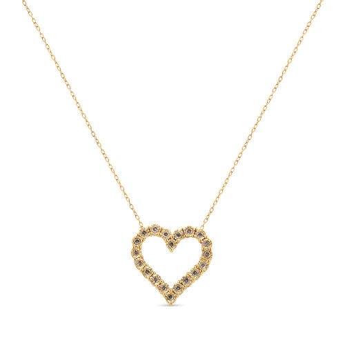 Gold heart-shaped necklace with embedded stones on a white background