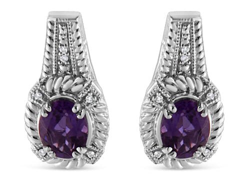 Pair of silver earrings with purple gemstones on a white background