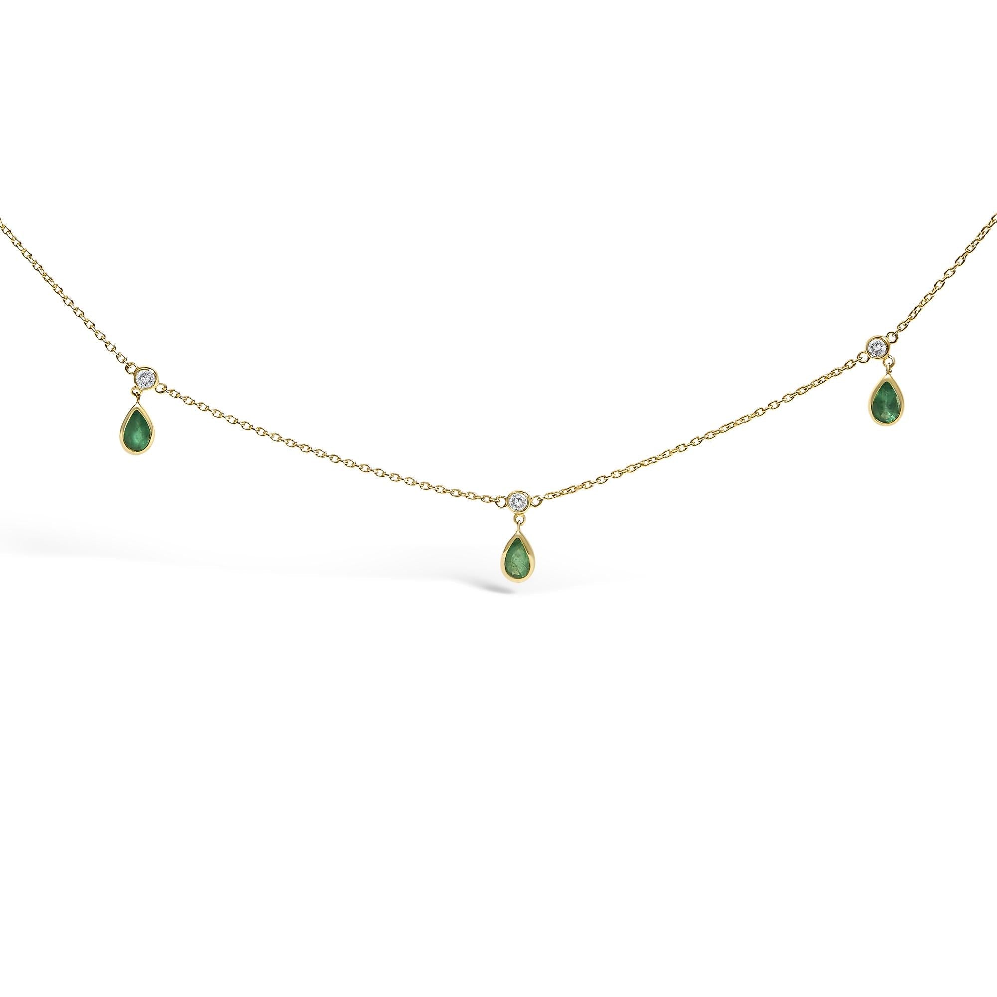Gold necklace with green teardrop-shaped pendants on a white background