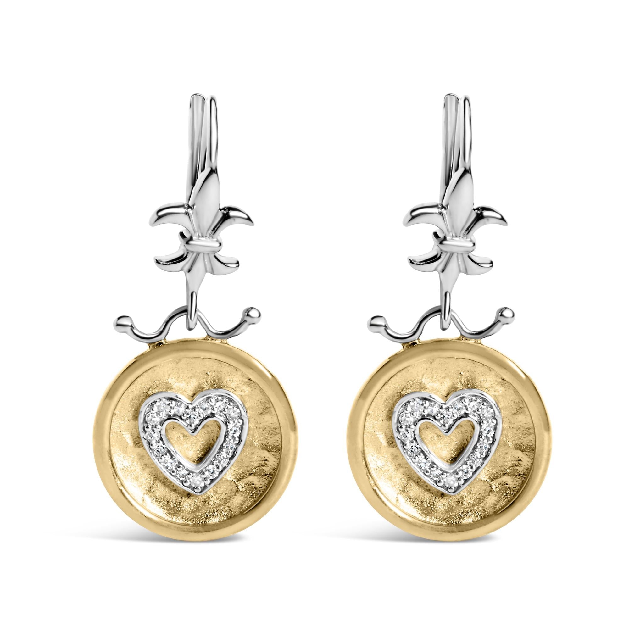 Pair of earrings with gold and silver designs on a white background