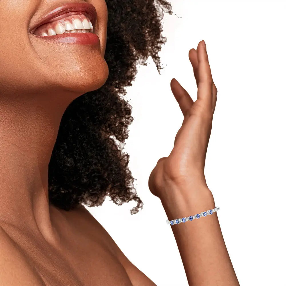Oval tanzanite and 1/4 cttw diamond bangle bracelet in 14k white gold bijoux-nyc direct
