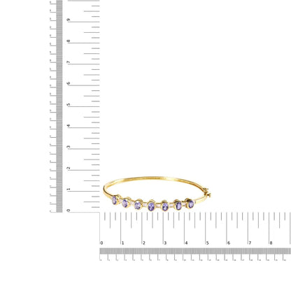 14k yellow gold alternating bezel set 5mm oval shaped tanzanite and 1/5 cttw diamond bangle bracelet (h i color vs2 si1 clarity)