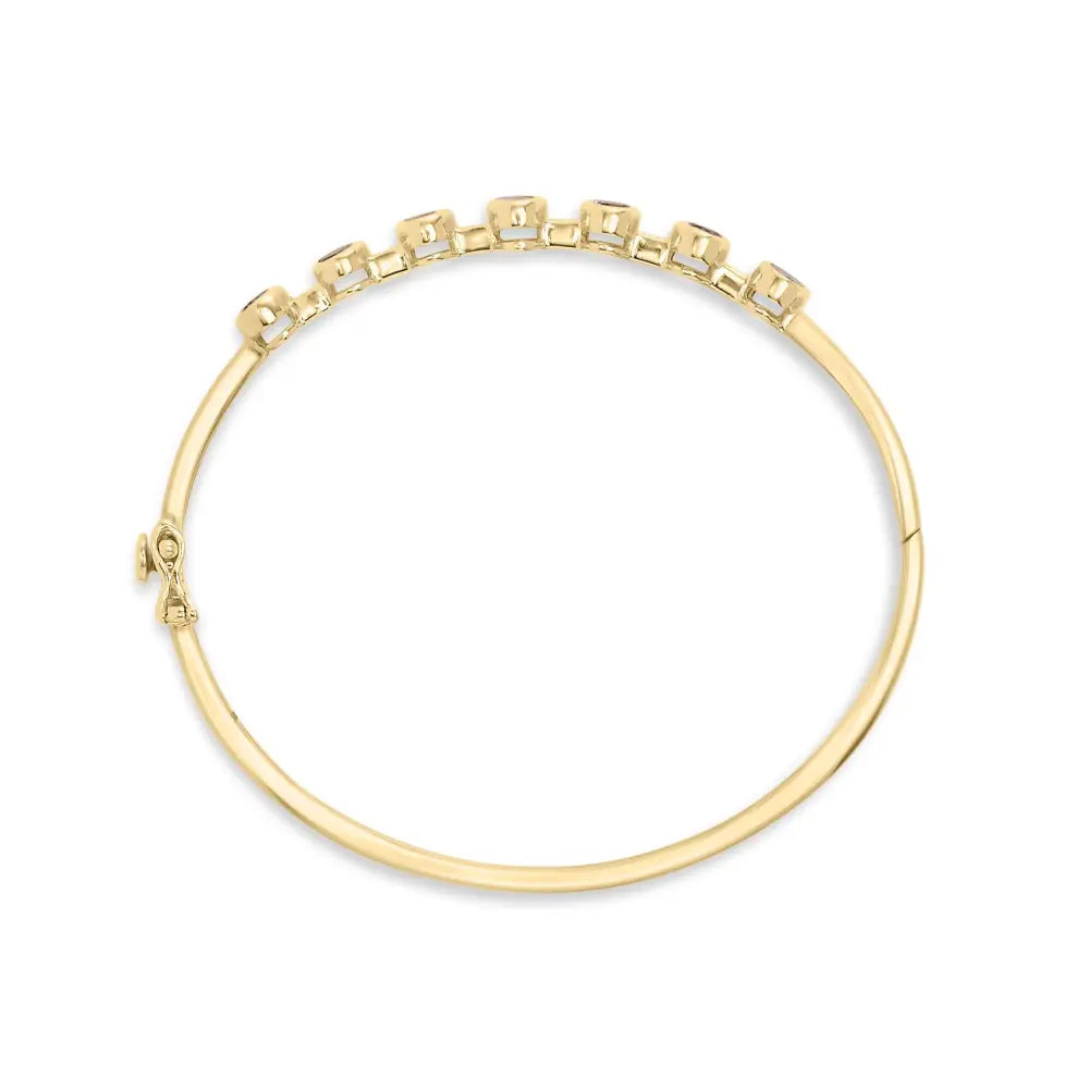 14k yellow gold alternating bezel set 5mm oval shaped tanzanite and 1/5 cttw diamond bangle bracelet (h i color vs2 si1 clarity)