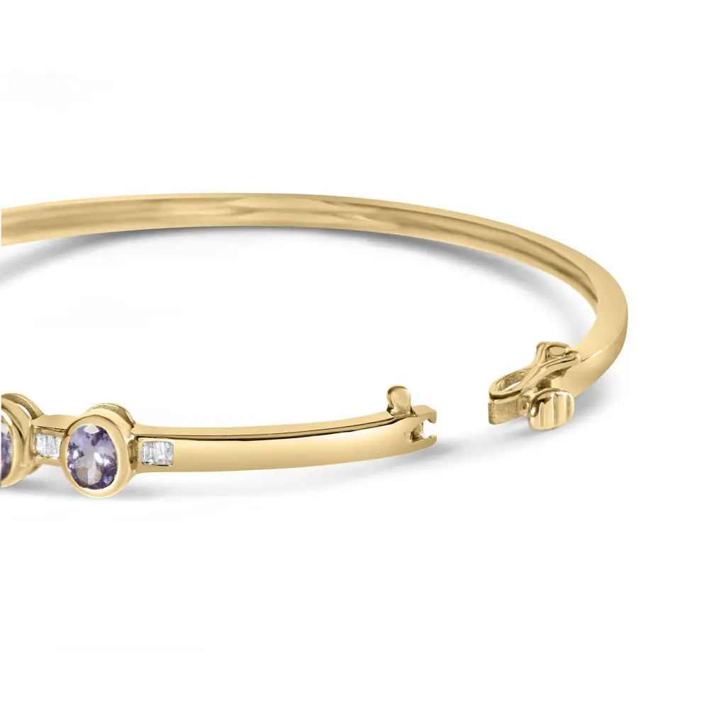 14k yellow gold alternating bezel set 5mm oval shaped tanzanite and 1/5 cttw diamond bangle bracelet (h i color vs2 si1 clarity)