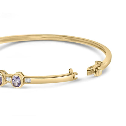 14k yellow gold alternating bezel set 5mm oval shaped tanzanite and 1/5 cttw diamond bangle bracelet (h i color vs2 si1 clarity)