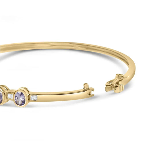 14k yellow gold alternating bezel set 5mm oval shaped tanzanite and 1/5 cttw diamond bangle bracelet (h i color vs2 si1 clarity)