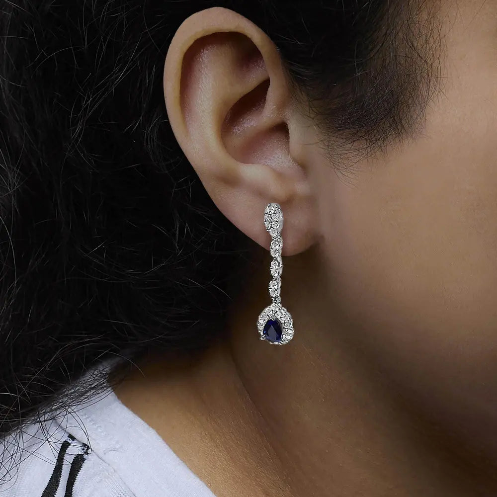 18K White Gold 1 3/5 Cttw Diamond and 7X5 MM Pear Shaped Blue Sapphire 1 1/3 Inch Drop and Dangle Halo Earrings (G-H Color, VS1-VS2 Clarity) - Bijoux-NYC Direct