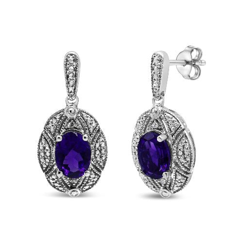 Pair of silver earrings with purple gemstones on a white background