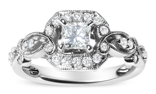 Silver ring with a large central diamond and smaller diamonds on a white background