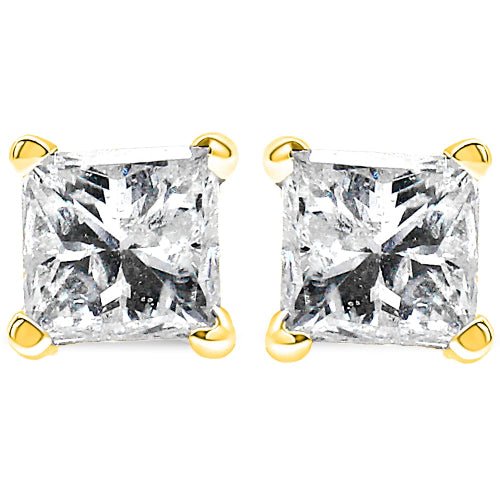 Pair of diamond stud earrings with gold prongs on a white background