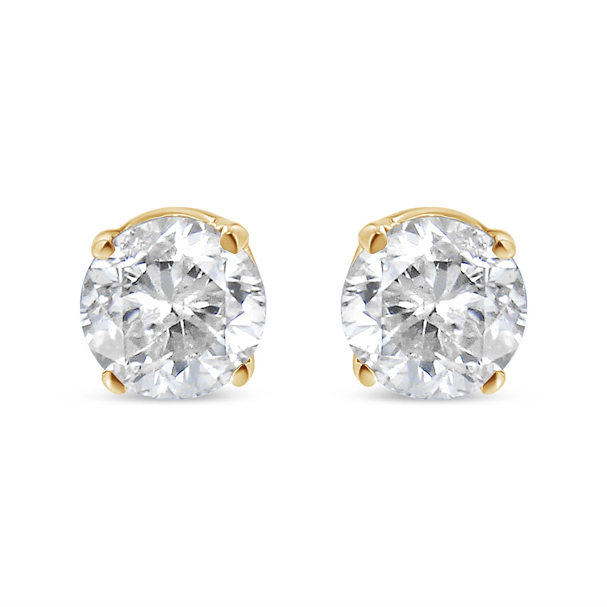 Pair of diamond stud earrings on a white background