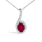 Diamond necklace with a central red gemstone on a white background