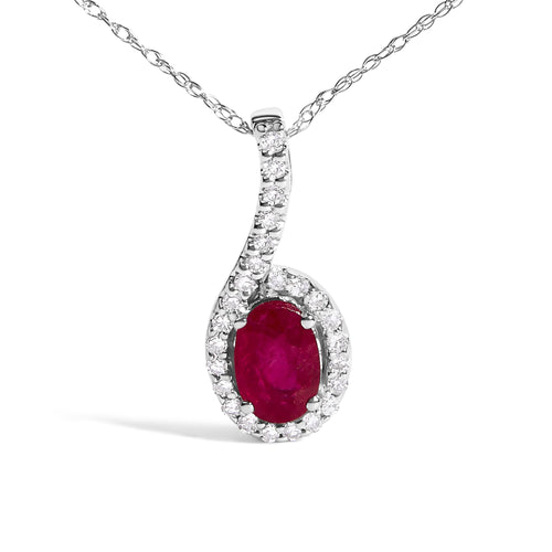 Diamond necklace with a central red gemstone on a white background