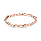Rose gold bracelet with diamond accents on a white background