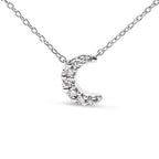 Silver necklace with a crescent moon pendant on a white background