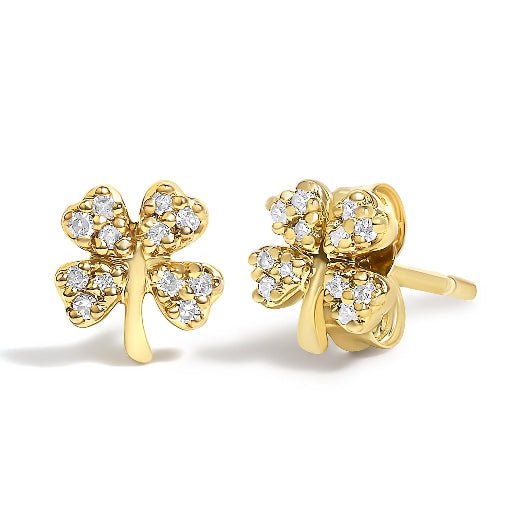 Gold four-leaf clover earrings with diamond accents on a white background