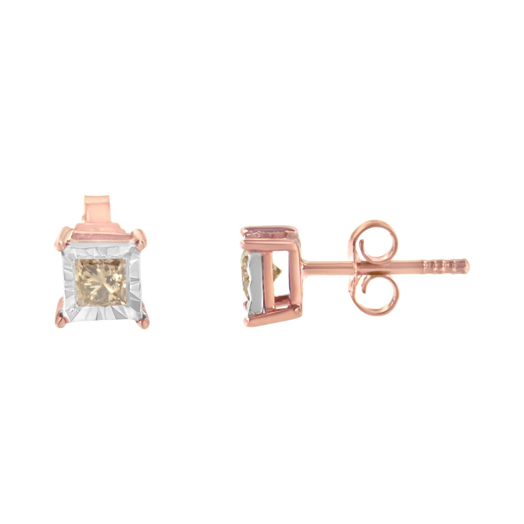 Rose gold earrings with clear gemstones on a white background