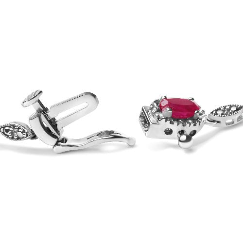 Silver cufflinks with a red gemstone on a white background