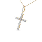 Gold and diamond cross pendant on a white background