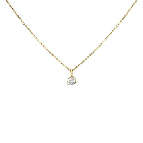 Gold necklace with a heart-shaped diamond pendant on a white background