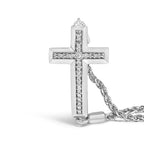 Silver cross pendant with chain on a white background