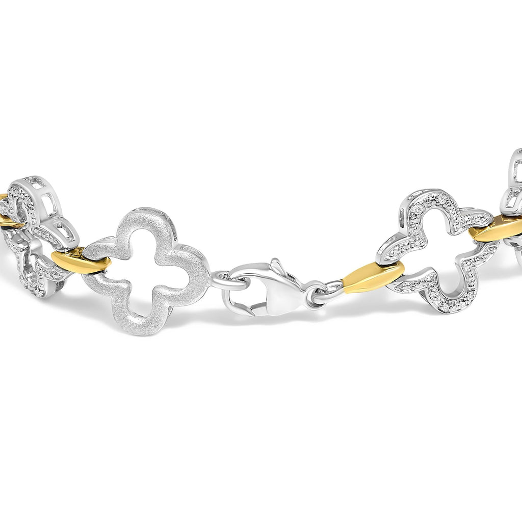 Bracelet with floral links in gold and silver on a white background