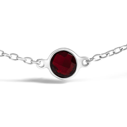Silver bracelet with a red gemstone on a white background