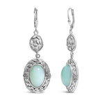 Silver earrings with light blue stones on a white background