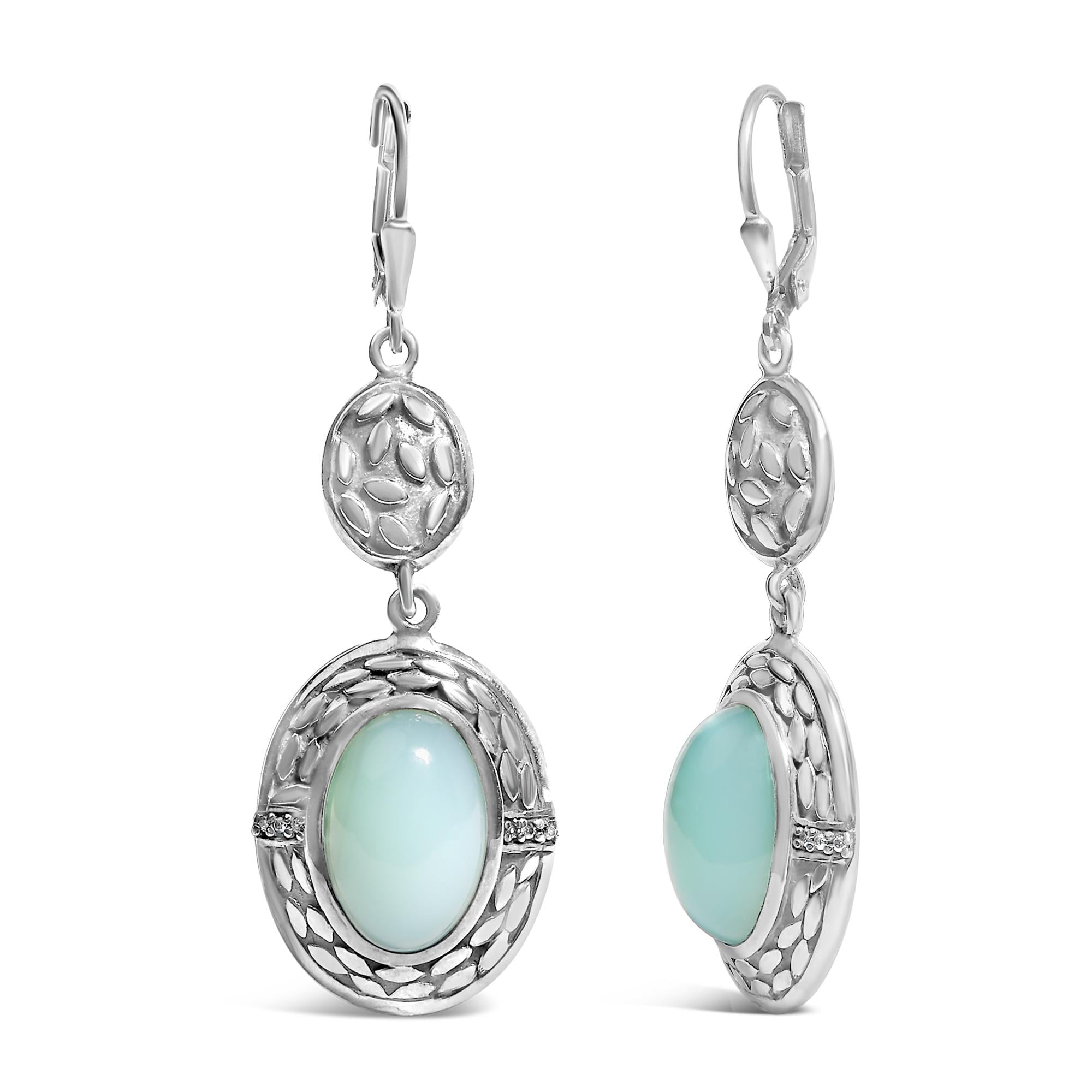 Silver earrings with light blue stones on a white background
