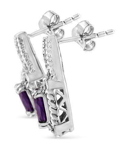 Silver earrings with purple stones on a white background