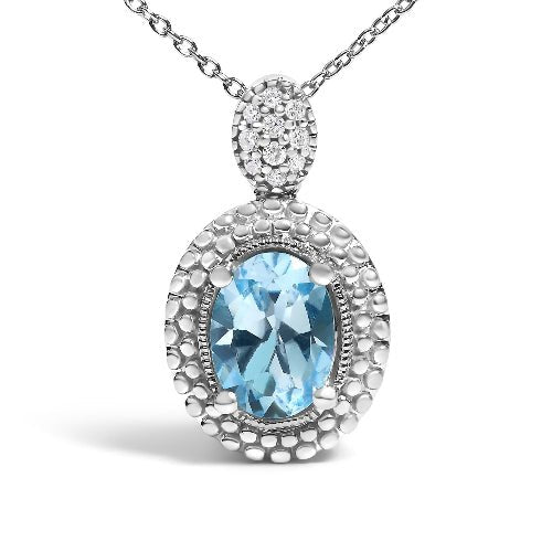 Silver pendant with blue gemstone and diamond accents on a white background