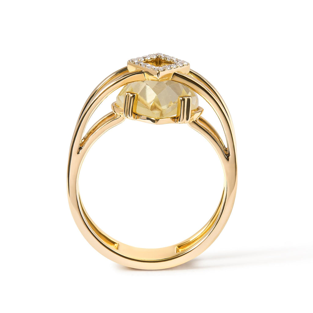 Gold ring with a yellow gemstone on a white background