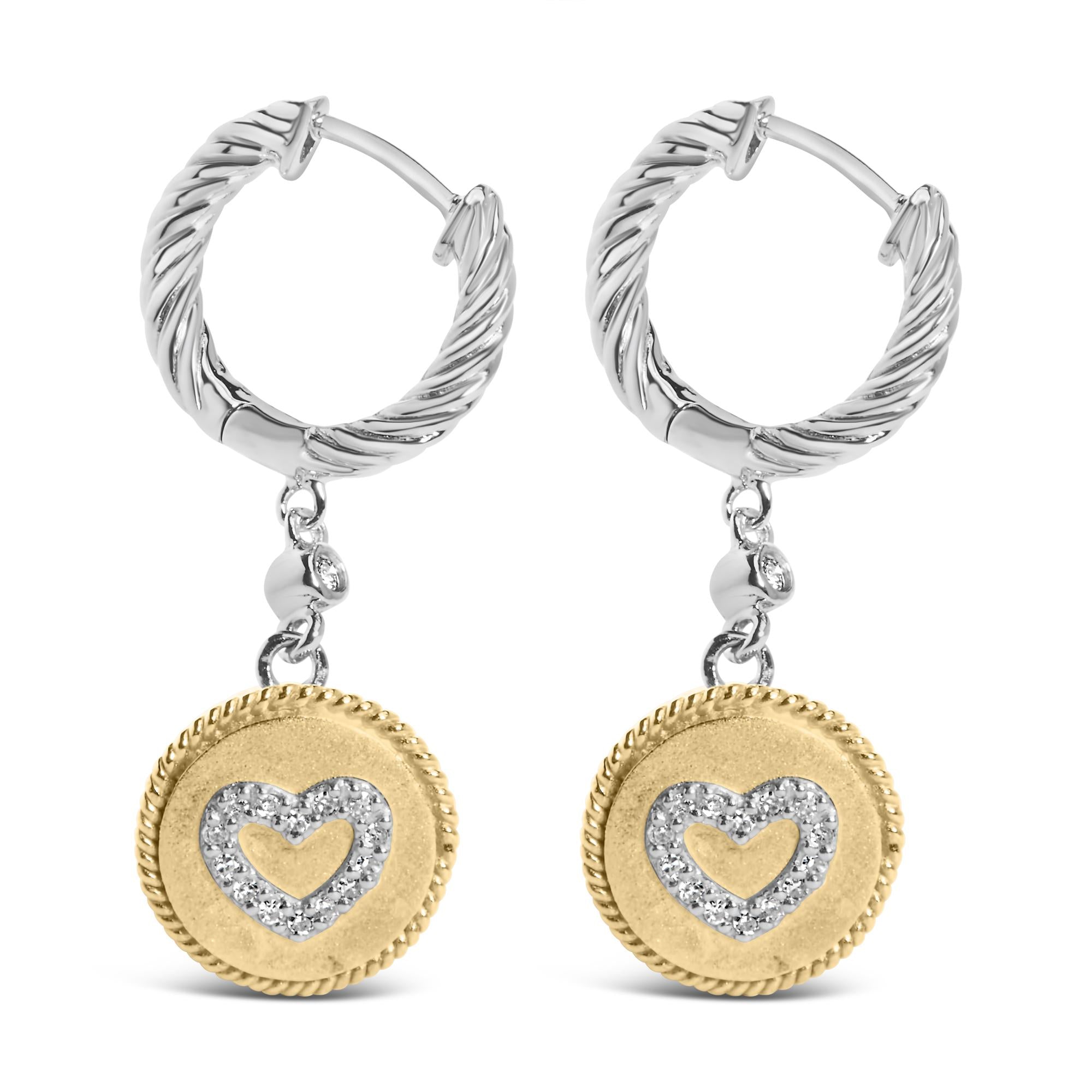 Pair of hoop earrings with gold and silver heart-shaped pendants on a white background
